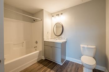 an empty bathroom with a toilet sink and shower at Crogman School Lofts in Atlanta, GA